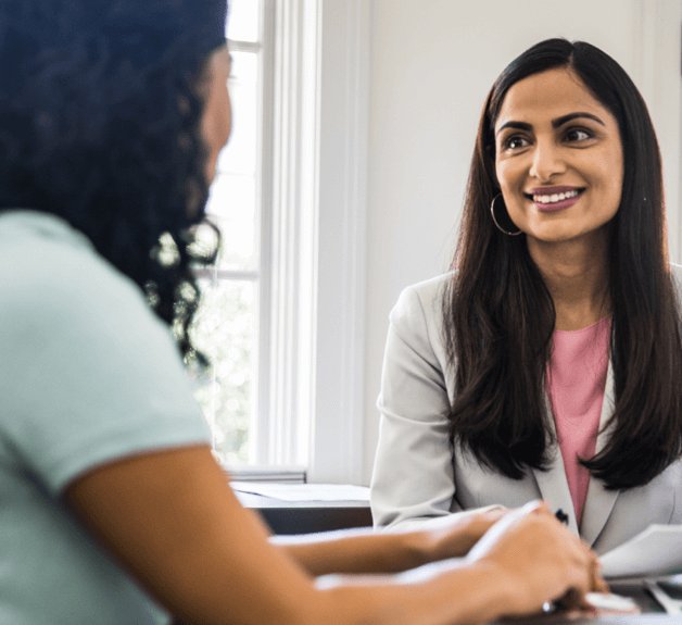 Two women sharing notes and collaborating