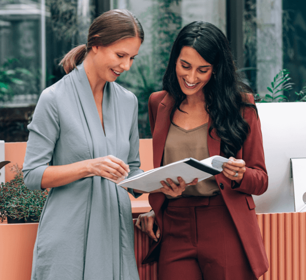 Two women looking at documents together